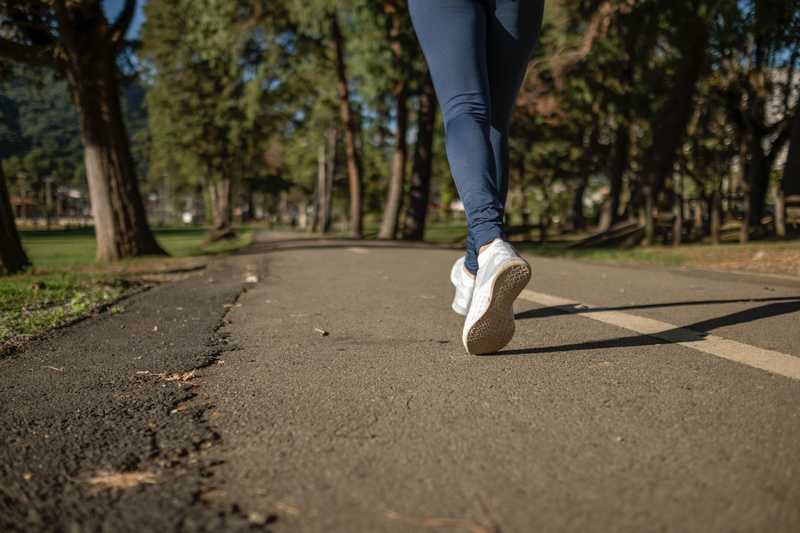 woman's legs running on path